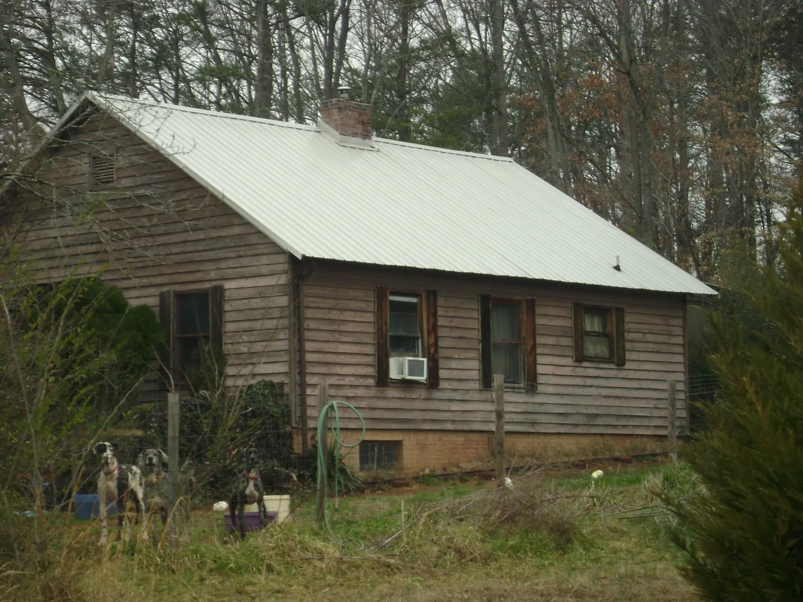 White metal roof on an old wood sided farmhouse, from a Metal Roof Installation job in Ellenwood
